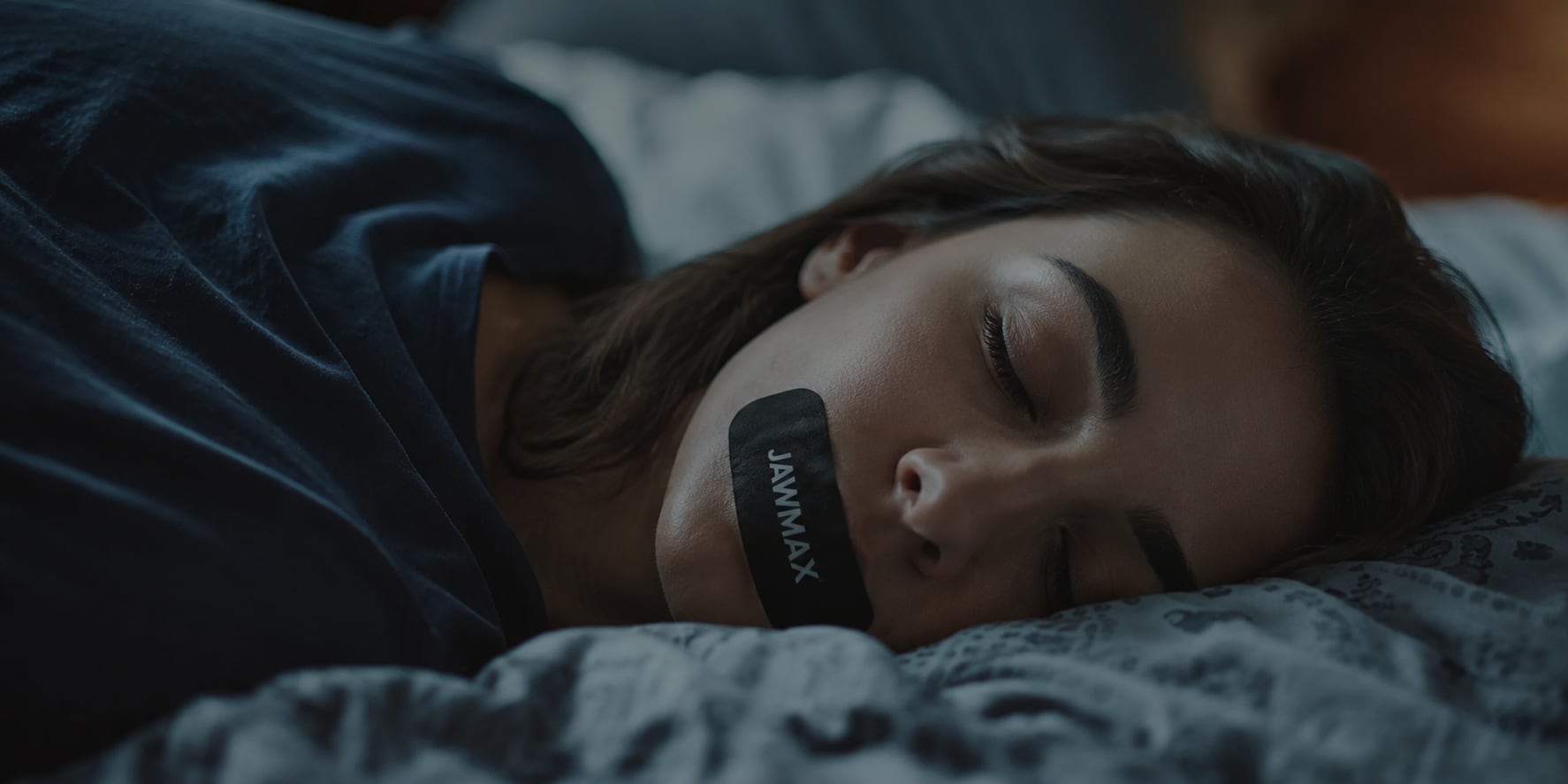 A woman sleeping calmly wearing JAWMAX mouth tape